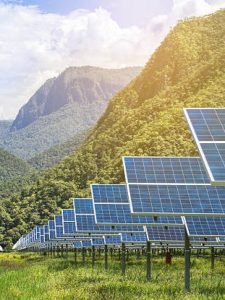 solar photovoltaics panels in solar power station with mountains background